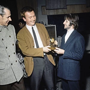 Ringo Starr sings into a toy gramaphone after sound engineer Geoff Emerick won a Grammy