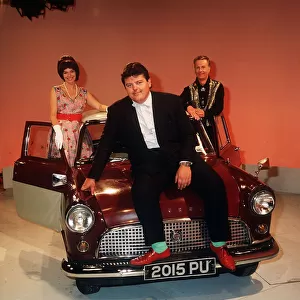 Robbie Coltrane actor pictured sitting on the bonnet of a mini Circa 1990