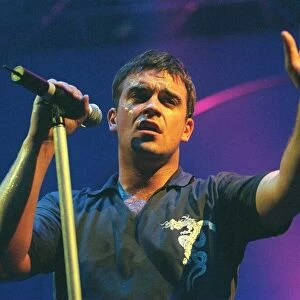Robbie Williams waves to the audience at his concert in Aberdeen. February 1999
