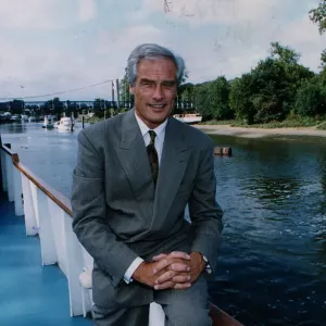 Robert Kilroy Silk former MP - TV Presenter on boat beside river grey suit