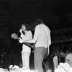 Robert Plant, lead singer of rock group Led Zeppelin, performing on stage during a