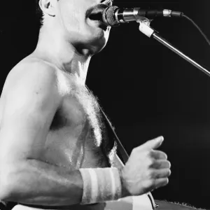 Rock group Queen in concert at Wembley Arena. Lead singer Freddie Mercury Rock group Queen in concert at Wembley Arena. Lead singer Freddie Mercury