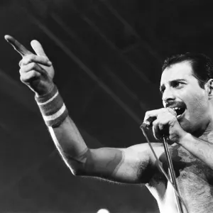 Rock group Queen in concert at Wembley Arena. Lead singer Freddie Mercury Rock group Queen in concert at Wembley Arena. Lead singer Freddie Mercury