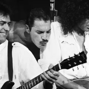Rock group Queen in concert at Wembley Arena. Lead singer Freddie Mercury Rock group Queen in concert at Wembley Arena. Lead singer Freddie Mercury