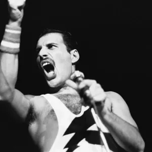 Rock group Queen in concert at Wembley Arena. Lead singer Freddie Mercury Rock group Queen in concert at Wembley Arena. Lead singer Freddie Mercury