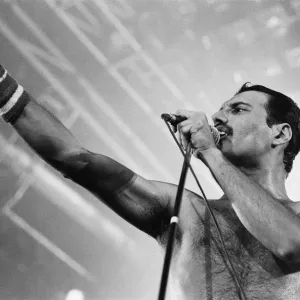 Rock group Queen in concert at Wembley Arena. Lead singer Freddie Mercury Rock group Queen in concert at Wembley Arena. Lead singer Freddie Mercury