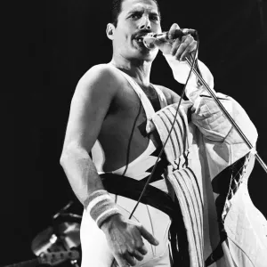Rock group Queen in concert at Wembley Arena. Lead singer Freddie Mercury Rock group Queen in concert at Wembley Arena. Lead singer Freddie Mercury