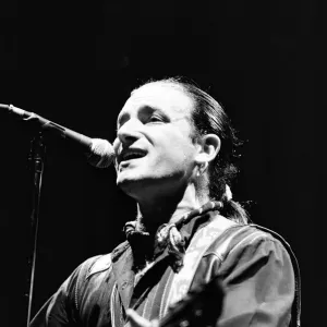 Rock group U2 in concert in USA. Bono singing and playing guitar. May 1987 Rock group U2 in concert in USA. Bono singing and playing guitar. May 1987