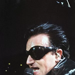 Rock group U2 performing on stage at Cardiff Arms Park led by singer Bono