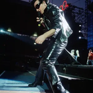 Rock group U2 performing on stage at Cardiff Arms Park led by singer Bono