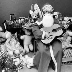 Rod Johnson, a guitar playing Father Christmas, surrounded by toys Rod Johnson, a guitar playing Father Christmas, surrounded by toys