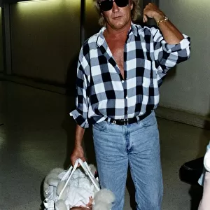 Rod Stewart Singer With baby daughter leaving Heathrow