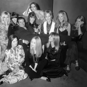 Rod Taylor with some of the girls who will appear in his new film Rod Taylor with some of the girls who will appear in his new film