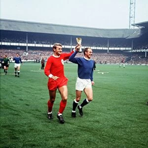Roger Hunt football player for Liverpool and Ray Wilson of Everton run around Goodison