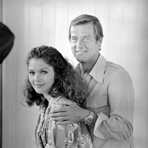 Roger Moore with actress Lois Chiles at a photocall and reception held in Paris to