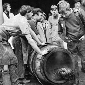 Roll out the barrel. A coopers apprentice is rolled out in a smoking barrel as part of