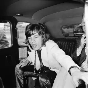 Rolling Stones lead singer Mick Jagger arrives at London Heathrow Airport with Marianne Rolling Stones lead singer Mick Jagger arrives at London Heathrow Airport with Marianne
