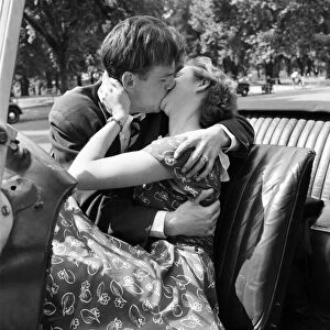 Romance. A young couple in love kissing. August 1953 D5205-004