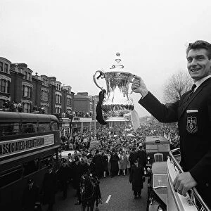 Ron Henry holds the FA Cup on the open top bus May 1962 during the Tottenham
