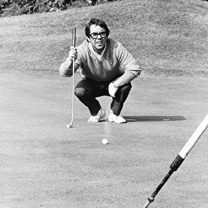 Ronnie Corbett Comedian crouches down to eye up a putt during a golf match dbase