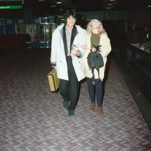 Ronnie Wood and his wife Jo at Heathrow Airport. 28th February 1991 Ronnie Wood and his wife Jo at Heathrow Airport. 28th February 1991