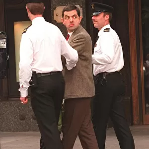 Rowan Atkinson Actor as Mr Bean filming at Harrods - being arrested by policemen