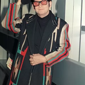 Roy Orbison at Heathrow Airport November 1988 in multi coloured coat holding