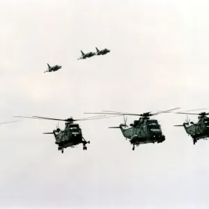 Four Royal Navy Sea King helicopters and three Sea Harriers in flight Four Royal Navy Sea King helicopters and three Sea Harriers in flight