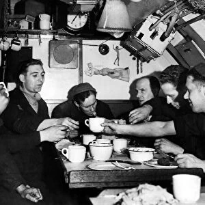 Royal Navy at War. Members of the crew gather in the submarine mess room