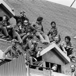 The royal tour of Switzerland. Pictured, locals sitting on a roof hoping to see the royal