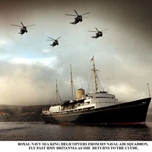 Royal Yacht Britannia accompanied by four Royal Navy Sea King Helicopters as it sails up