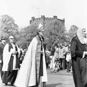 The Rt Revd Dr John Habgood the Bishop of Durham strikes the doors of the Cathedral with