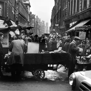 Rupert Street, Soho. Fruit and Veg is sold from a cart outside Boots. Circa 1955 Rupert Street, Soho. Fruit and Veg is sold from a cart outside Boots. Circa 1955