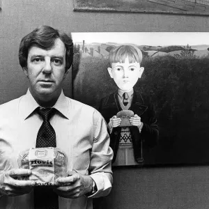 Russell Harty, television presenter at home. He is holding a loaf of Hovis Bread Russell Harty, television presenter at home. He is holding a loaf of Hovis Bread