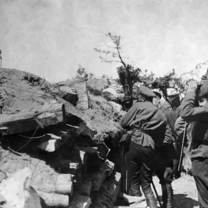 A Russian officer seen watching the movement of the enemy though field glasses whilst a A Russian officer seen watching the movement of the enemy though field glasses whilst a
