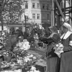 Russian Red Cross nurses seen here in the market place in Lemberg buying flowers for Russian Red Cross nurses seen here in the market place in Lemberg buying flowers for