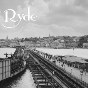 Ryde Esplanade and Pier, Isle of Wight. A steam train pulls out of the station on the end