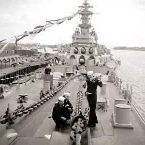A US sailors about to drop one of the US Iowa anchors as it docks at Portsmouth