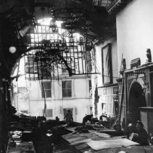 Salvage workers shift through the wreckage the Guildhall after a direct hit