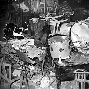 Salvage workers sort through the damaged band instruments at the Cafe de Paris following