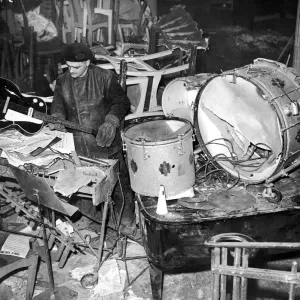 Salvage workers sort through the damaged band instruments at the Cafe de Paris following Salvage workers sort through the damaged band instruments at the Cafe de Paris following