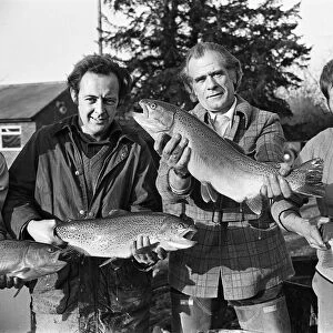 Sam Holland (centre) and trout famers holding trout. 13th February 1976