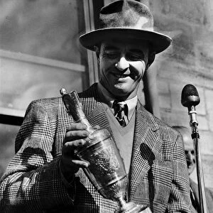Sam Snead holding the British Golf Open trophy he has won
