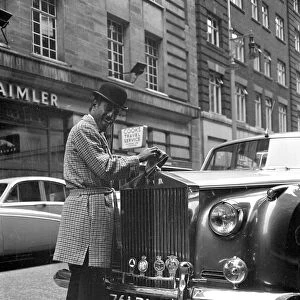 Sammy Davis Jnr. in London polishing his new Rolls Royce. 31st March 1963