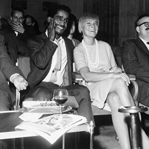 Sammy Davis Jnr with his wife, actress May Britt, watching an extract of his new film