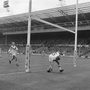 Sampson of Wakefield Trinity scores under Wigans the posts shortly before the half time Sampson of Wakefield Trinity scores under Wigans the posts shortly before the half time