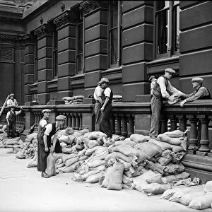 Sandbags being placed against the walls of the Birmingham Education Committee building in