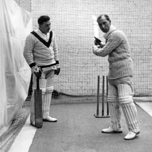 Sandham demonstrating a batting stroke to a pupil at the indoor cricket school opened Sandham demonstrating a batting stroke to a pupil at the indoor cricket school opened