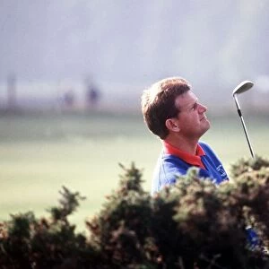 Sandy Lyle standing in rough looking up October 1988
