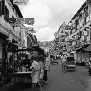 Scenes in Chinatown, Singapore, where old meets new. Clean washing is poked out from Scenes in Chinatown, Singapore, where old meets new. Clean washing is poked out from